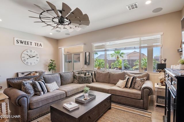 living area featuring visible vents, ceiling fan, recessed lighting, and light wood finished floors