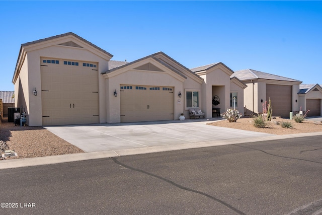 ranch-style house featuring concrete driveway, stucco siding, and an attached garage