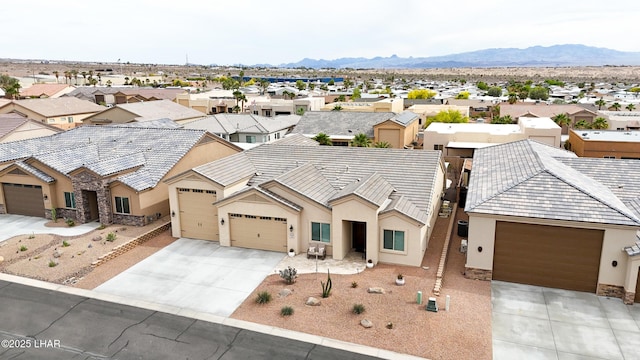 view of front of property featuring a residential view, driveway, stucco siding, and an attached garage