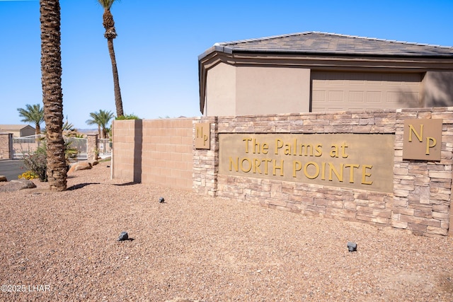 community sign featuring fence