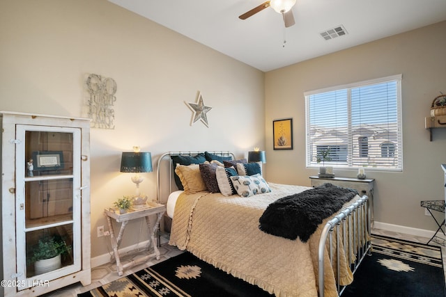 bedroom with visible vents, baseboards, and a ceiling fan