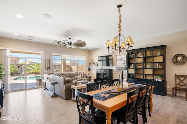 dining area with light wood-type flooring, an inviting chandelier, visible vents, and recessed lighting