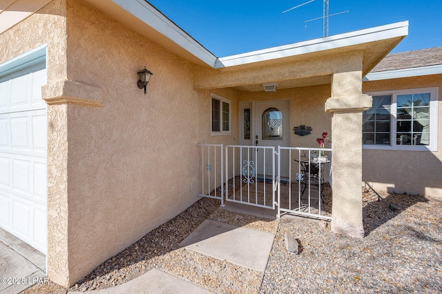 view of exterior entry featuring a garage