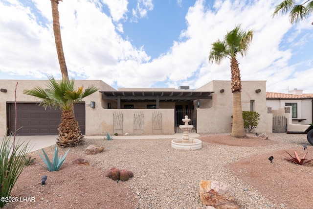 view of front of property with a garage, driveway, and stucco siding