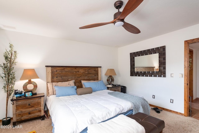 carpeted bedroom featuring a ceiling fan and baseboards