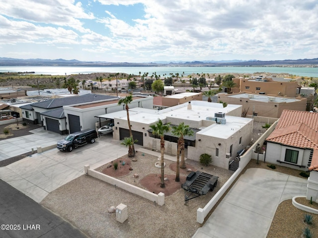 drone / aerial view with a water view and a residential view