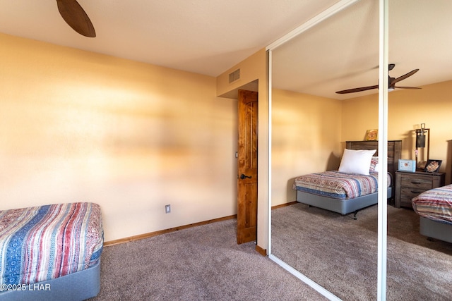 carpeted bedroom with baseboards, visible vents, and a ceiling fan