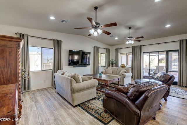 living room featuring vaulted ceiling, light hardwood / wood-style floors, and ceiling fan