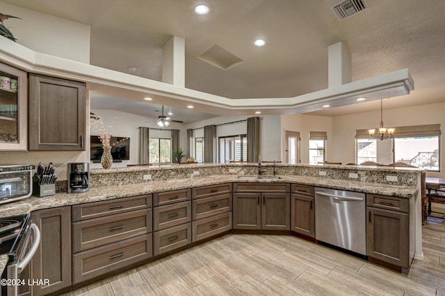 kitchen featuring light stone counters, sink, a wealth of natural light, and stainless steel appliances