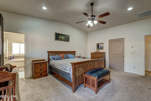 carpeted bedroom with ceiling fan, connected bathroom, and vaulted ceiling