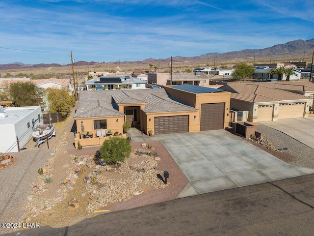 view of front of house with a garage and a mountain view