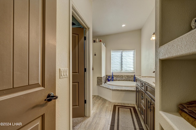 bathroom featuring vanity and a tub