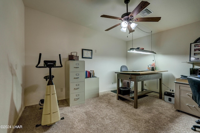 carpeted home office featuring lofted ceiling and ceiling fan