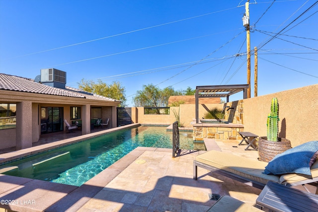 view of swimming pool with a patio, central air condition unit, and a bar