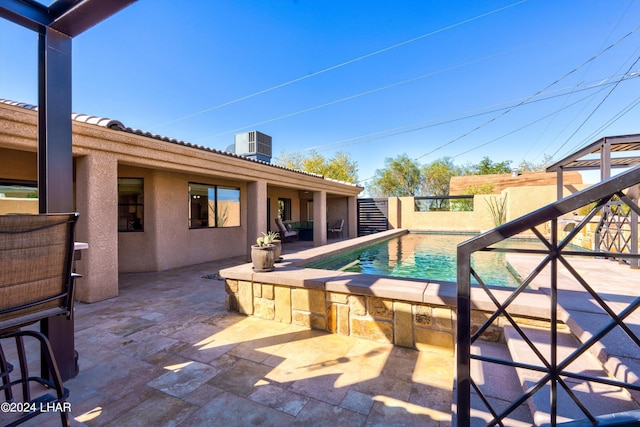 view of swimming pool featuring a patio and central air condition unit