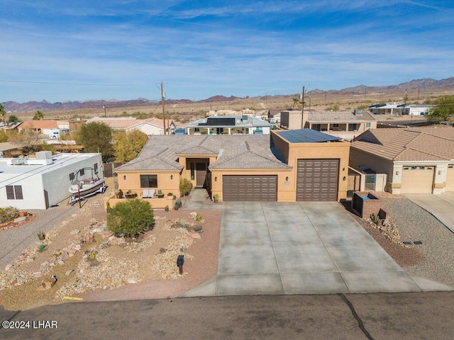 view of front of property featuring a mountain view and a garage