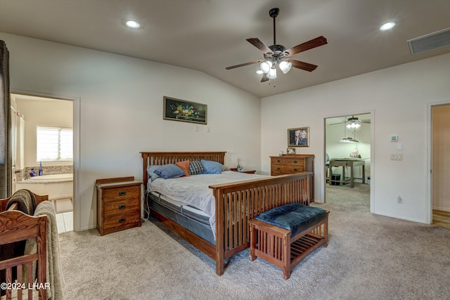 bedroom with ceiling fan, ensuite bath, lofted ceiling, and light carpet