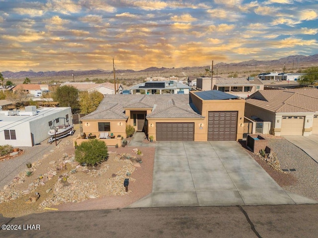 view of front facade with a garage and a mountain view