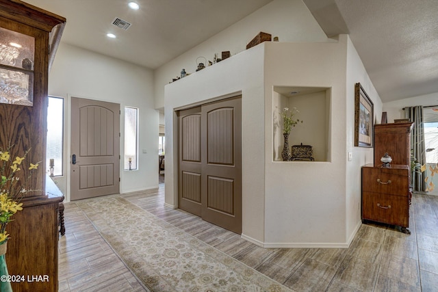 entrance foyer with a wealth of natural light and high vaulted ceiling