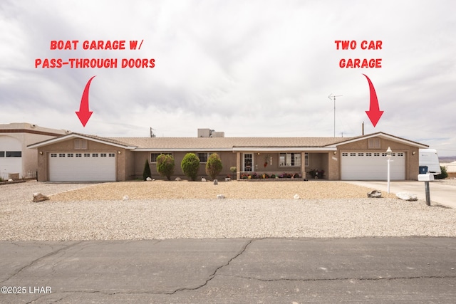 view of front of home with a garage, stucco siding, and driveway