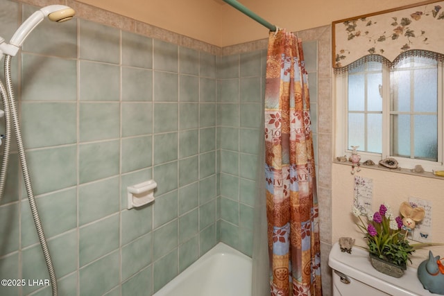 bathroom with shower / bath combo and toilet