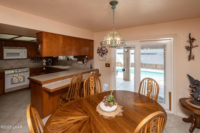 dining room with a chandelier and light tile patterned flooring