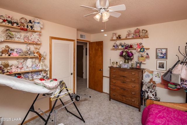 carpeted bedroom with visible vents and a ceiling fan