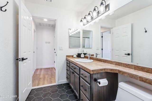 1921 Burgundy Ln, Lake Havasu City, AZ 86404 - bathroom featuring tile patterned floors, visible vents, toilet, vanity, and baseboards