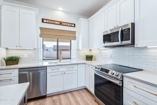 1921 Burgundy Ln, Lake Havasu City, AZ 86404 - kitchen with white cabinetry, stainless steel appliances, light countertops, and a sink