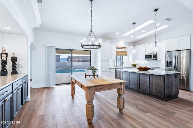 1921 Burgundy Ln, Lake Havasu City, AZ 86404 - kitchen featuring stainless steel appliances, visible vents, white cabinetry, and tasteful backsplash