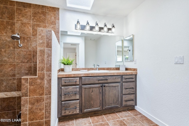 1921 Burgundy Ln, Lake Havasu City, AZ 86404 - bathroom featuring tile patterned flooring, baseboards, vanity, and tiled shower