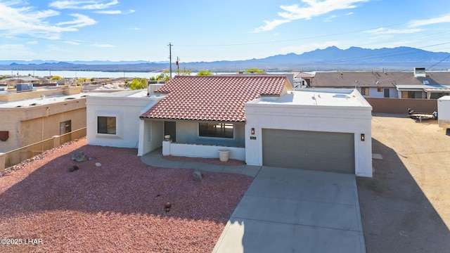 1921 Burgundy Ln, Lake Havasu City, AZ 86404 - view of front of property featuring a tiled roof, a mountain view, concrete driveway, a garage, and stucco siding