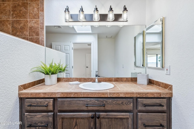 1921 Burgundy Ln, Lake Havasu City, AZ 86404 - bathroom with visible vents, a textured wall, and vanity