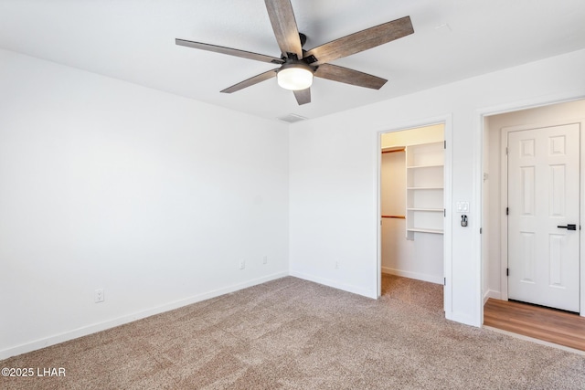 1921 Burgundy Ln, Lake Havasu City, AZ 86404 - unfurnished bedroom featuring a ceiling fan, a closet, a walk in closet, baseboards, and carpet flooring