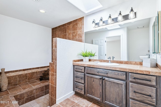 1921 Burgundy Ln, Lake Havasu City, AZ 86404 - bathroom with vanity, tile patterned floors, a walk in shower, and a skylight