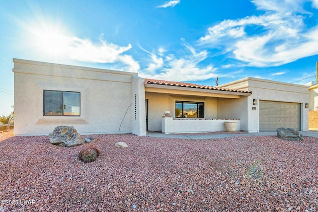 1921 Burgundy Ln, Lake Havasu City, AZ 86404 - mediterranean / spanish-style house featuring stucco siding, a tiled roof, and a garage