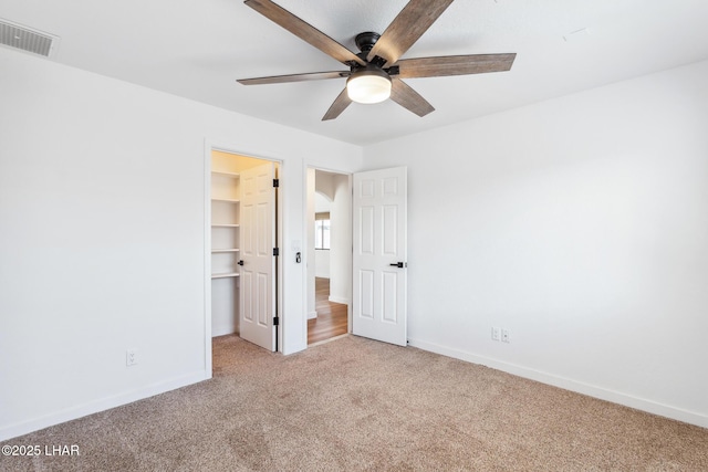 1921 Burgundy Ln, Lake Havasu City, AZ 86404 - unfurnished bedroom with a spacious closet, visible vents, a closet, baseboards, and carpet flooring