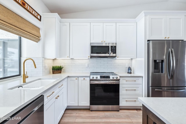 1921 Burgundy Ln, Lake Havasu City, AZ 86404 - kitchen featuring white cabinets, tasteful backsplash, stainless steel appliances, and a sink