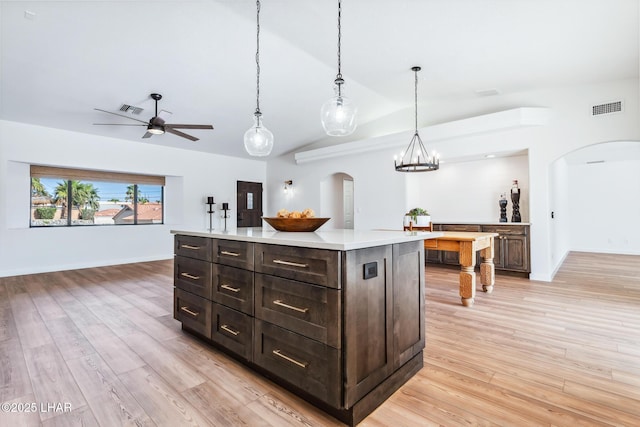 1921 Burgundy Ln, Lake Havasu City, AZ 86404 - kitchen with arched walkways, light countertops, vaulted ceiling, and visible vents