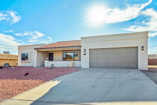 1921 Burgundy Ln, Lake Havasu City, AZ 86404 - mediterranean / spanish-style home with a garage, a tile roof, concrete driveway, and stucco siding