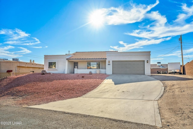 1921 Burgundy Ln, Lake Havasu City, AZ 86404 - view of front of home featuring a garage, a tile roof, stucco siding, and concrete driveway
