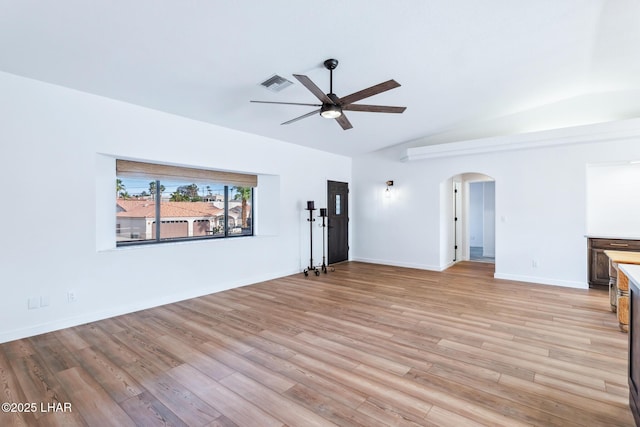 1921 Burgundy Ln, Lake Havasu City, AZ 86404 - unfurnished living room with light wood finished floors, vaulted ceiling, visible vents, arched walkways, and ceiling fan