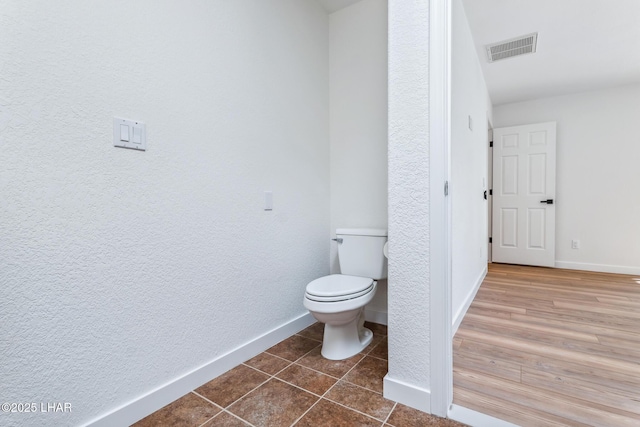 1921 Burgundy Ln, Lake Havasu City, AZ 86404 - bathroom with tile patterned floors, a textured wall, visible vents, toilet, and baseboards