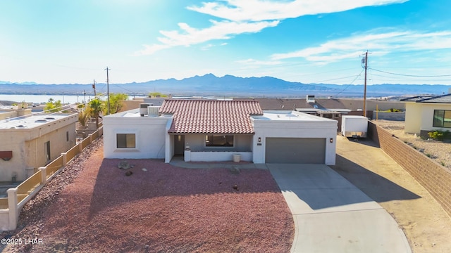 1921 Burgundy Ln, Lake Havasu City, AZ 86404 - view of front of house with a garage, driveway, stucco siding, and a mountain view