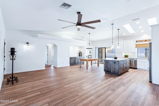 1921 Burgundy Ln, Lake Havasu City, AZ 86404 - kitchen with white cabinets, stainless steel appliances, a center island, visible vents, and light countertops