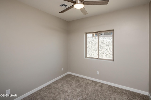 spare room featuring a ceiling fan, visible vents, carpet floors, and baseboards