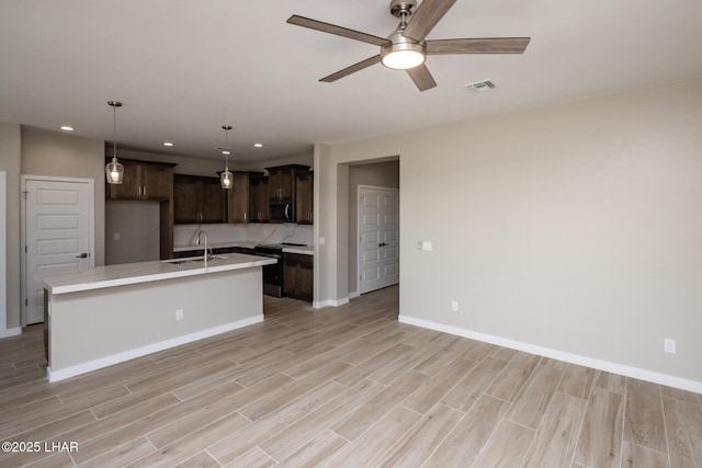 kitchen with baseboards, dark brown cabinetry, recessed lighting, and black electric range oven