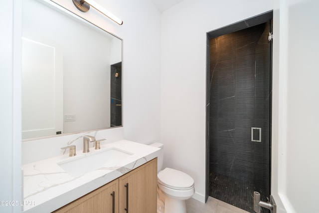 bathroom featuring tile patterned floors, a stall shower, toilet, and vanity