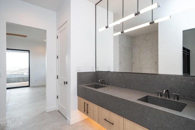 full bath featuring tasteful backsplash, double vanity, and a sink