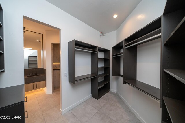 walk in closet with light tile patterned floors